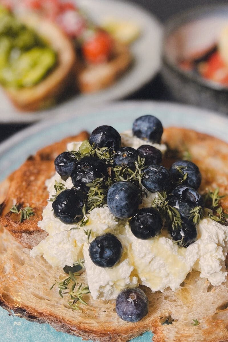 Mouthwatering toast topped with fresh blueberries and creamy ricotta cheese.