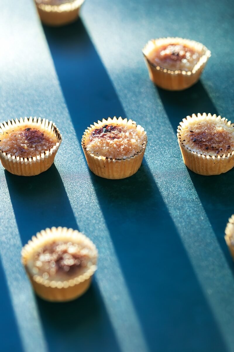 a group of cupcakes sitting on top of a blue table