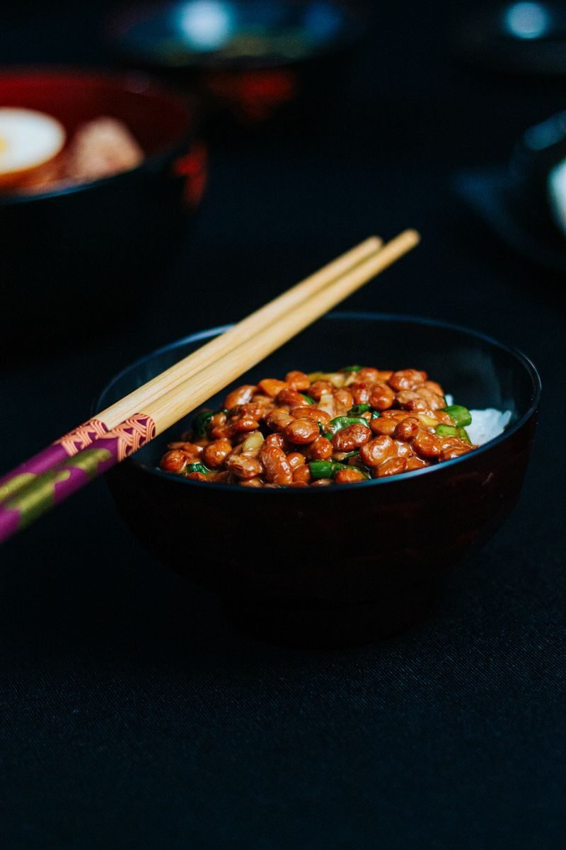 Close-up of a traditional Japanese natto dish served with chopsticks, perfect for Asian cuisine lovers.